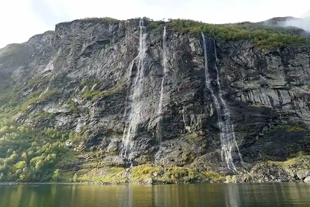 Deep fjords in Norway and a waterfall along Iceland's Ring Road